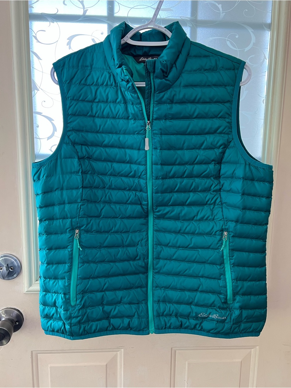 Eddie Bauer down filled quilted vest in teal colorway. Full zip, two zip pockets
